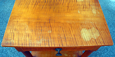 Significant moisture damage destroyed the top finish.